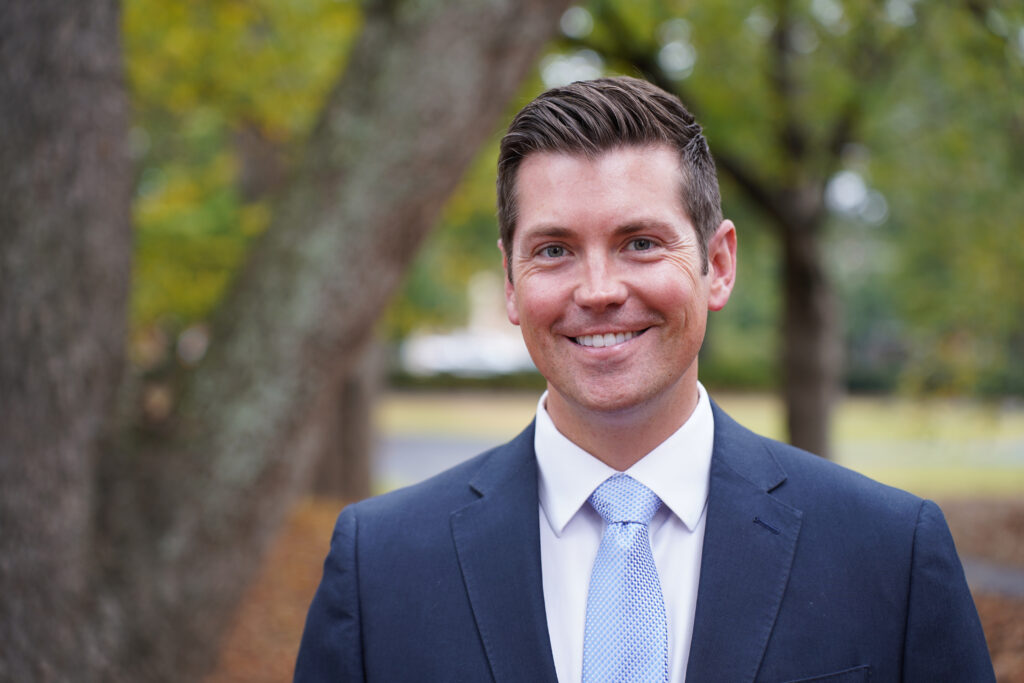 A headshot of Adam Hammond