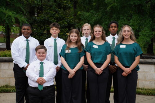 A group of eight students posing