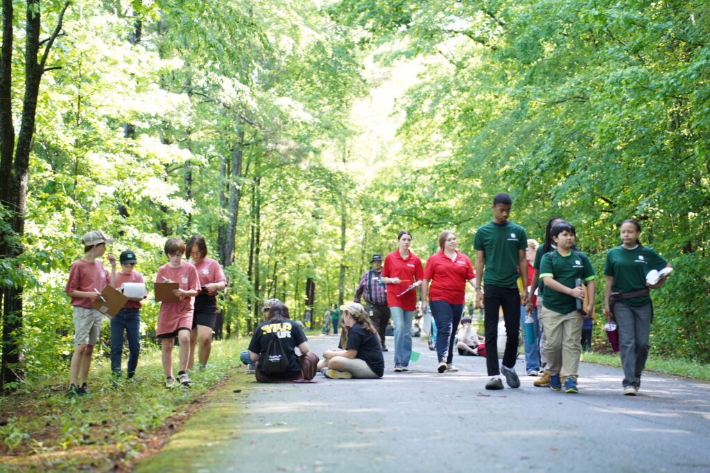A group of students in the forest at Rock Eagle 4-H Center