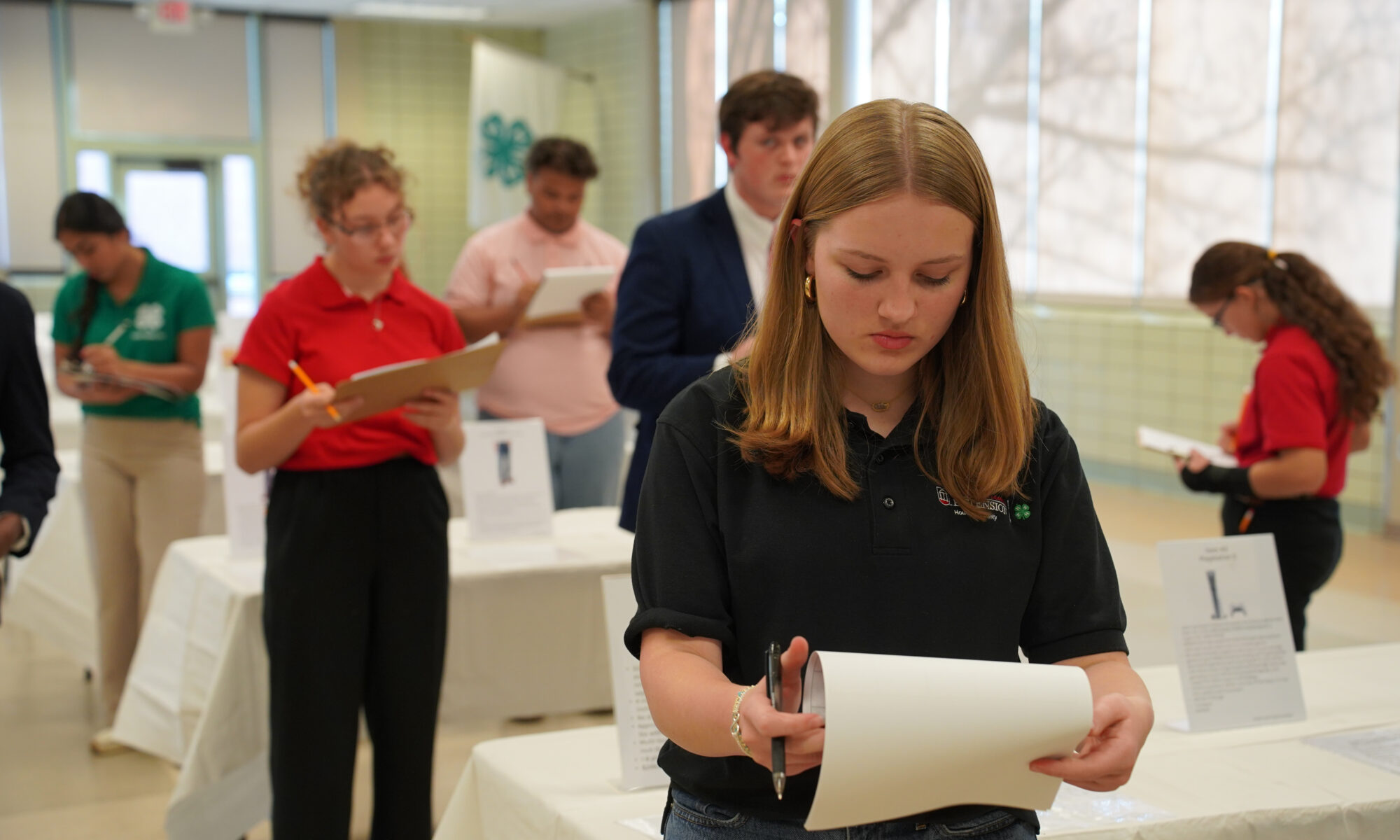 A contestant studying a clipboard