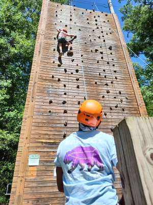 Student cimbing the climbing wall at Wahsega 4-H Center.