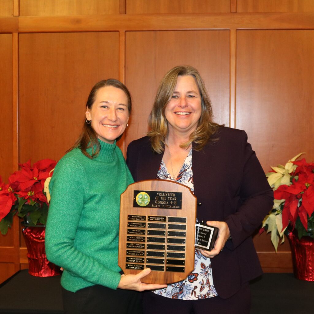Melanie Biersmith and Kristen Quinton posing with an award plaque